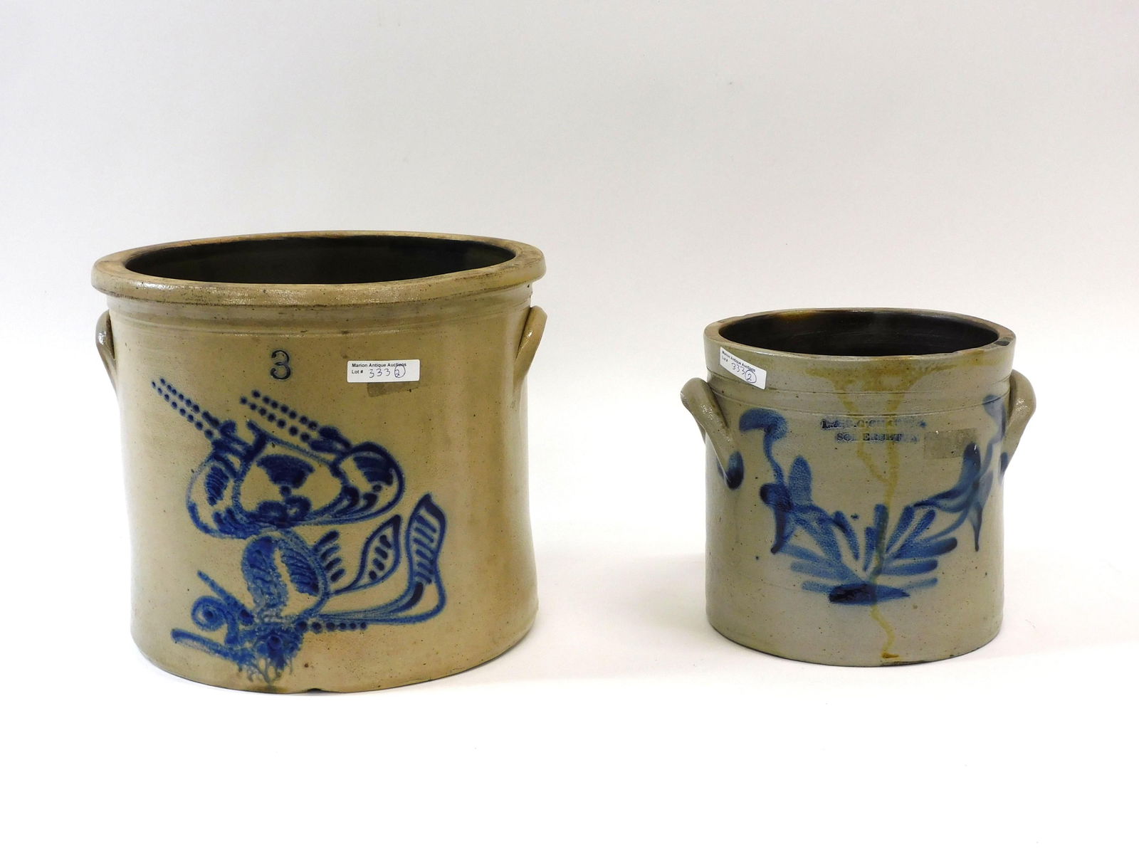 (2) Blue Decorated Stoneware Crocks: To include: 3 gallon with unusual insect design. 10" high x 11 1/2" diameter. With an approximate 8" crack. Together with, 1 1/2 gallon L & B.G. Chace Somerset crock with leaf and bush design. 7 3/4"