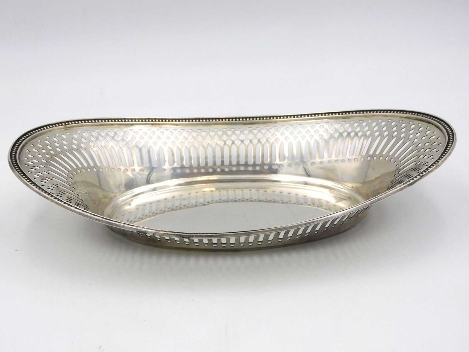 Tiffany Sterling Silver Tray: Open work border, 2 1/2" high x 10 1/2" long x 6 1/4" wide. Shows light scratching and small dents. 8.79 ozt. Please note: this must be paid for by wire transfer, known check, or cash. Items will be s