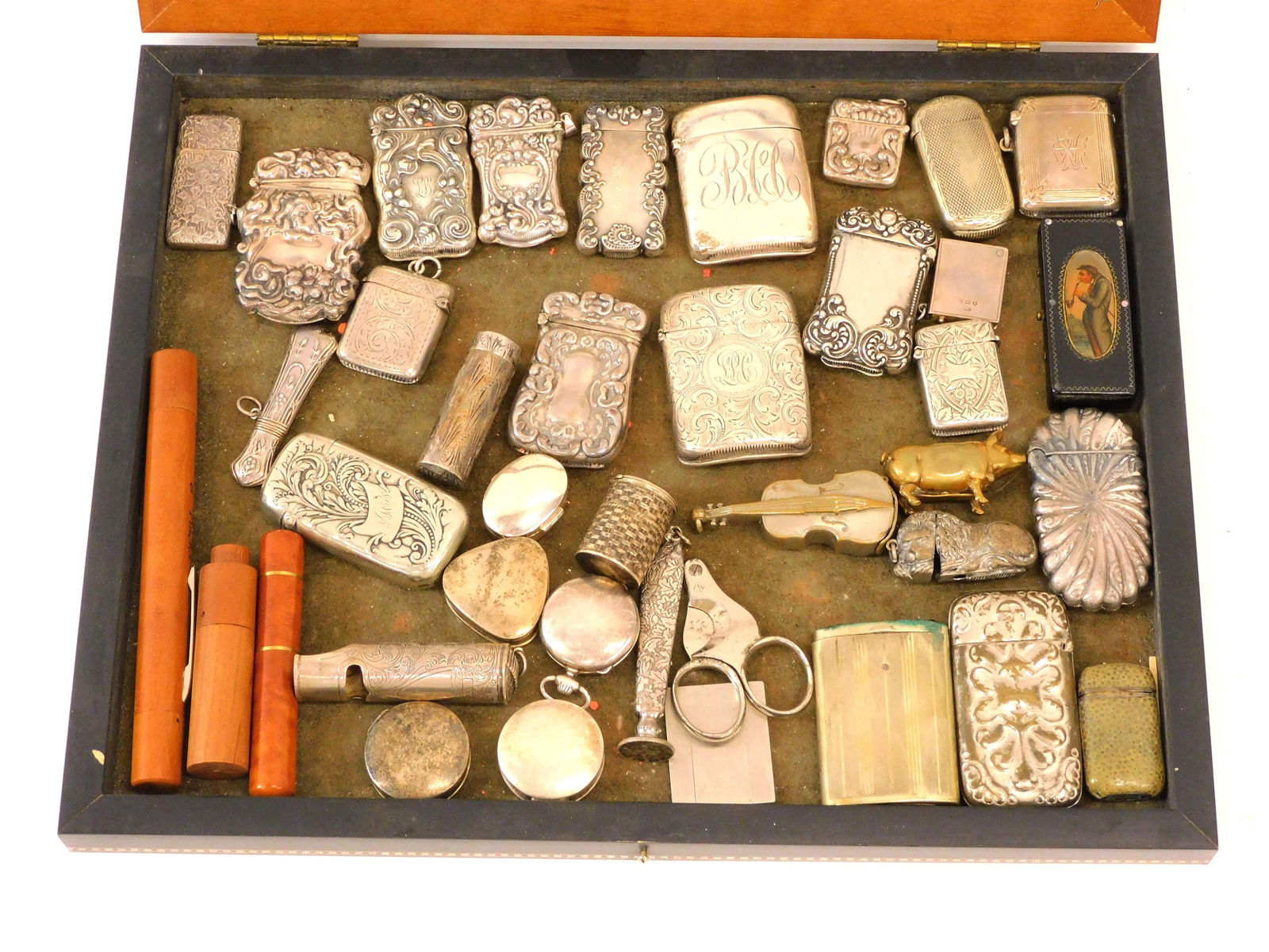 (39) Silver Match Safes And Other Items: To include: (19) sterling match holders. (3) figural match holders - lion, pig and cello. (4) misc. metal match holders, a 19th C lacquerware match holder, (6) silver pill boxes, (1) cigar stamp, (2)