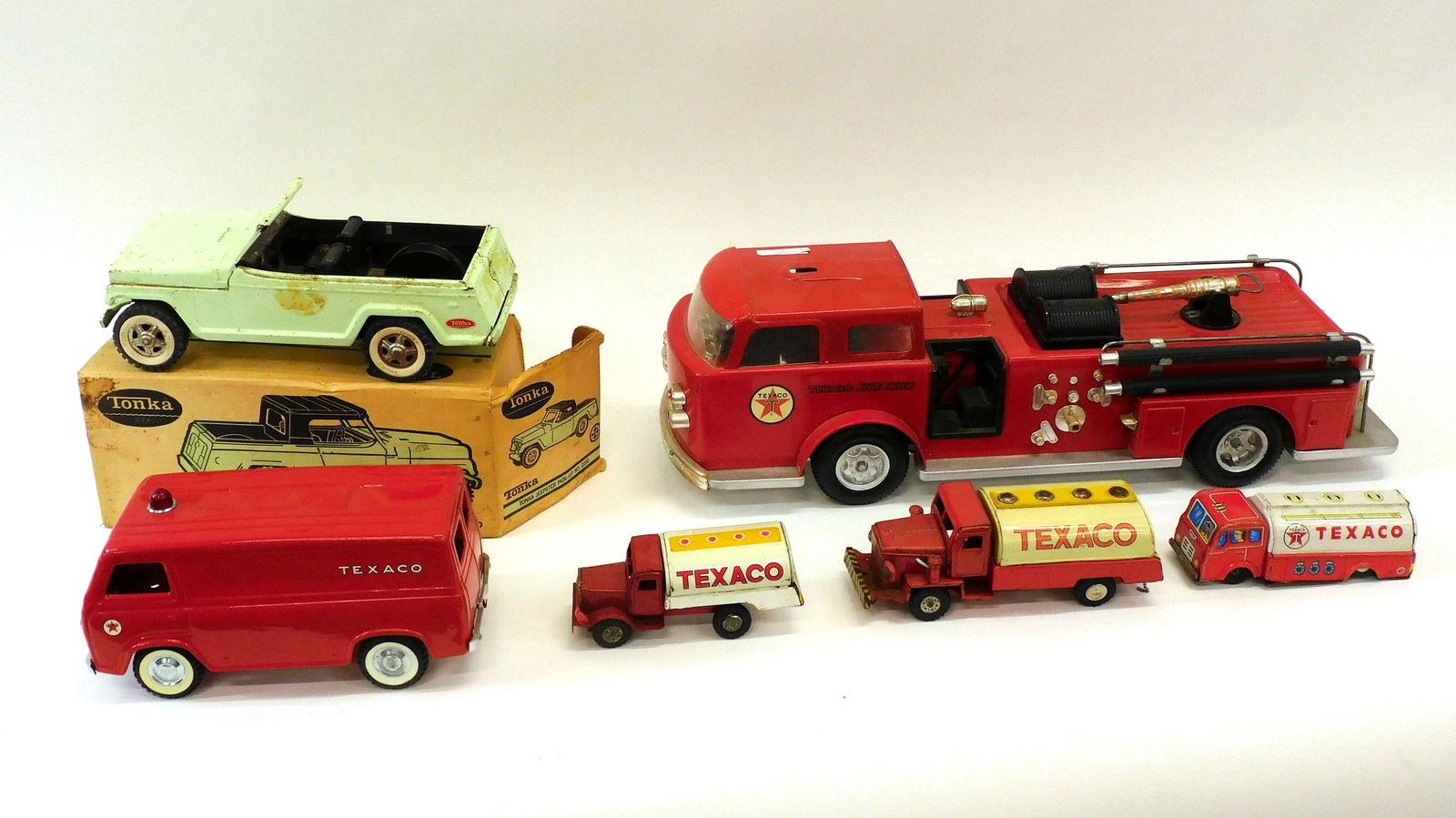 (6) Vintage Texaco And Other Toys: Collection of (6) 20th c. vintage toys including Nylint pressed steel Texaco Ford Econoline van, 11" L. Texaco stamped steel fire truck, 24 1/2" L. Tonka steel Jeepster in original box, as-found condi