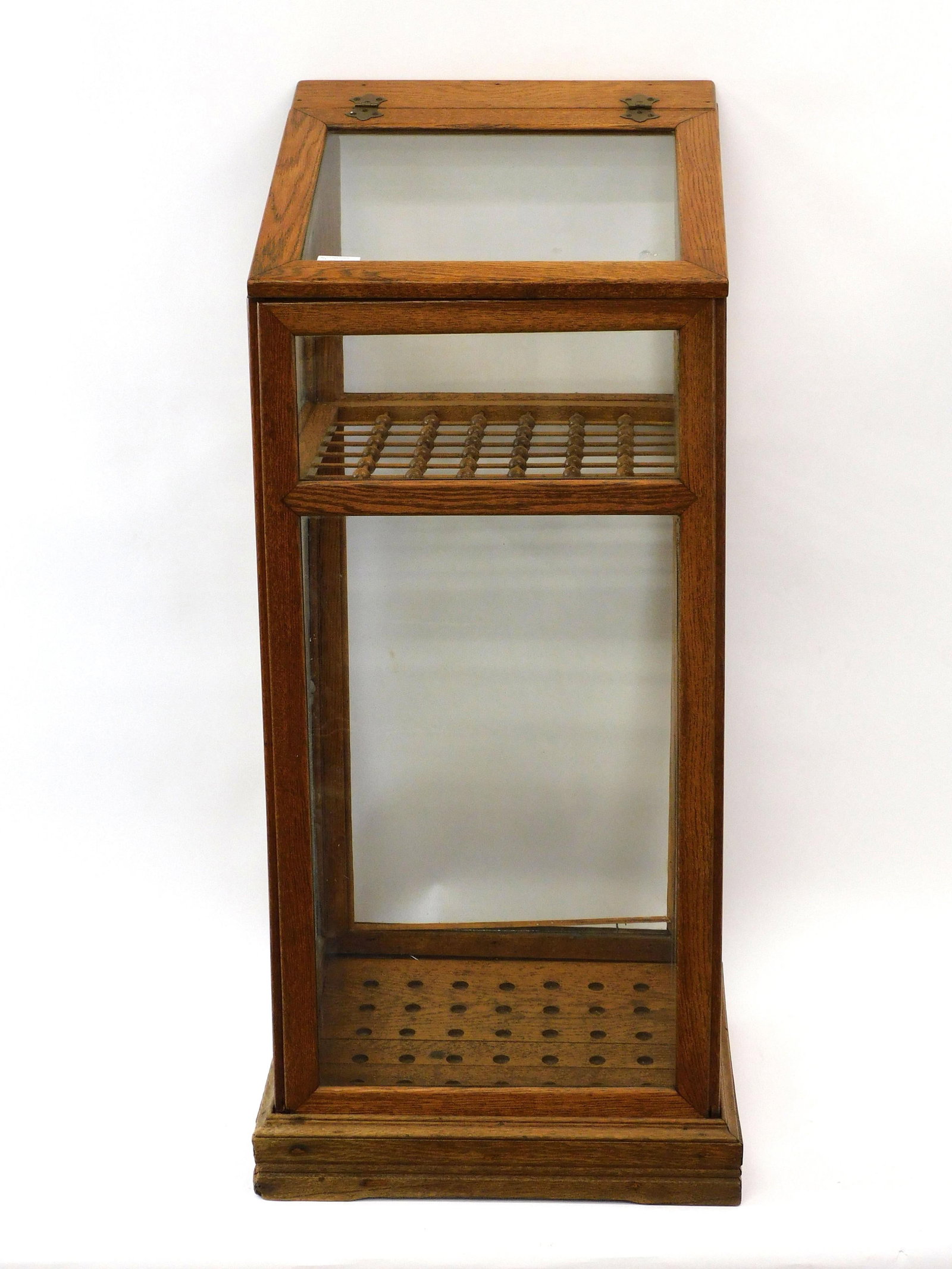 Cane Display Case: Circa 1900. Oak and glass. Stick and ball interior. Good condition. 48" high x 19 1/2" wide x 21" deep.