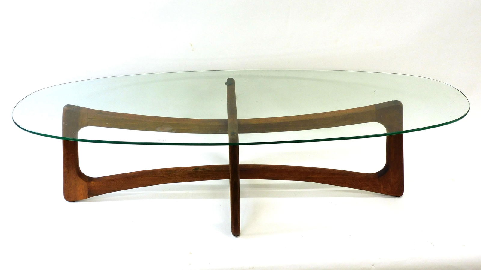 Adrian Pearsall Dog Bone Cocktail Table: Mid 20th c. Modern; walnut base, glass top. 16" H x 59" L x 19 3/4" D. Good overall condition, age appropriate wear.