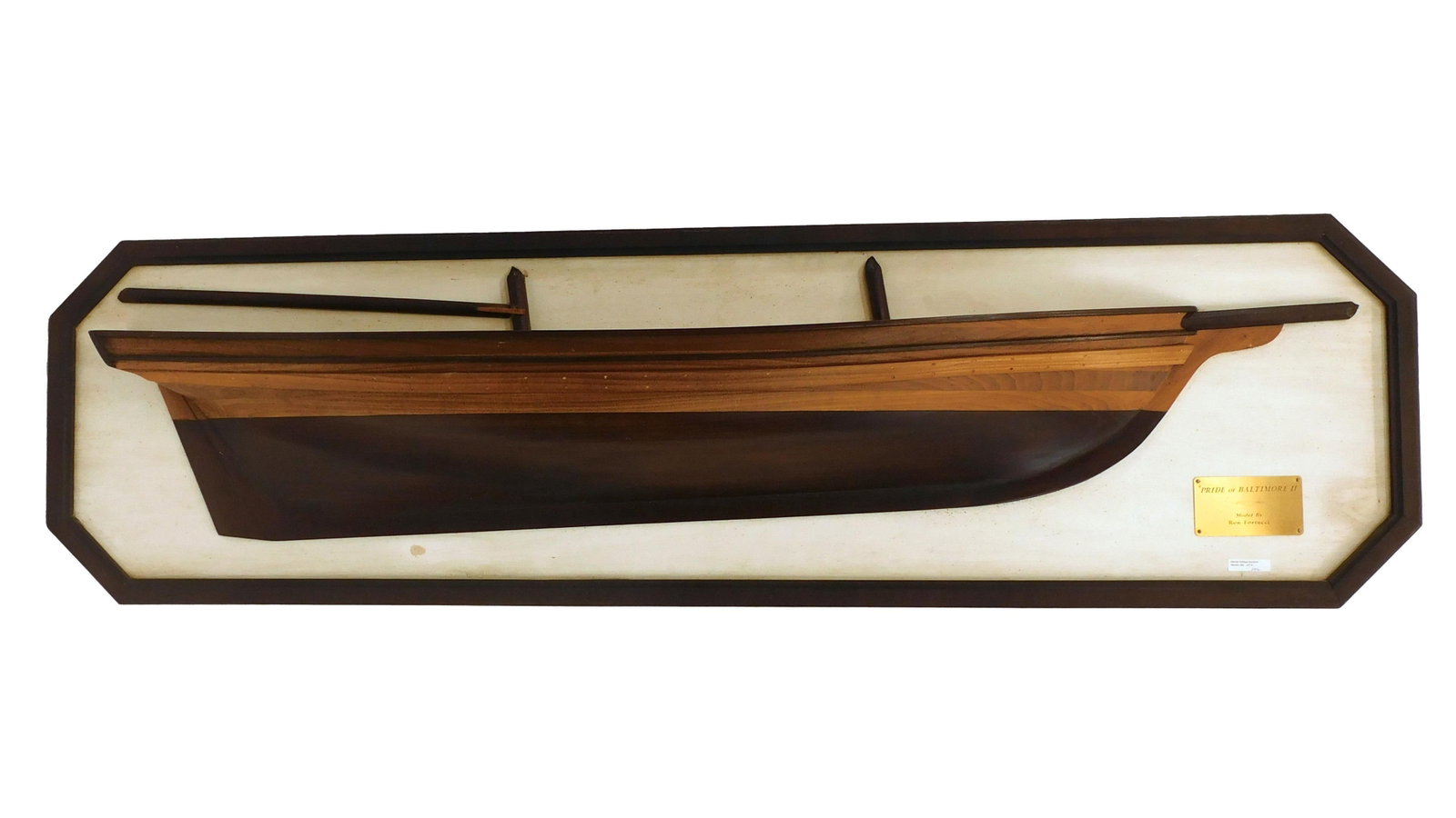 Half Hull Model.: 20th C. Model of Pride of Baltimore II. By Ron Fortucci. Mounted on a wooden plaque. The model is 56" long x 9 1/2" high x 6 1/2" deep. The plaque is 61" wide x 17" high x 1 1/2" deep. Natural finish.