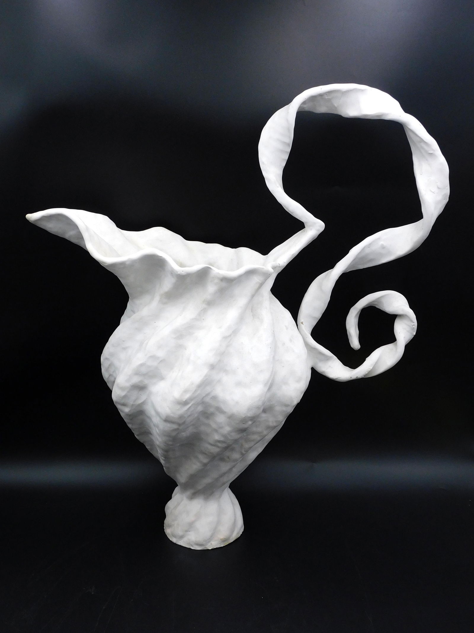 Peter Schlesinger Large Ceramic Pitcher: 1993. A ceramic earthenware sculptural vessel with white craquelure glaze. Incised initials and dated on base. 23" h x 19" w. 2 hairline cracks on handle. Otherwise good overall condition. From the co