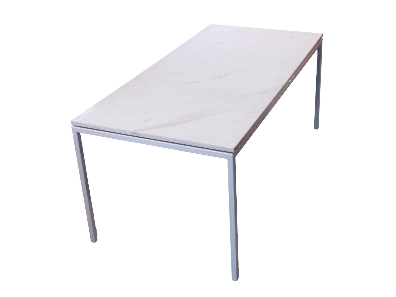 Florence Knoll Table: Mid-20th c.; White marble top. White painted steel base. Unmarked. 26" h x 60L x 29-1/2" w. Minor surface scratches and abrasions. Very minor flake at corner. From the collection of Doris Lockhart Saa