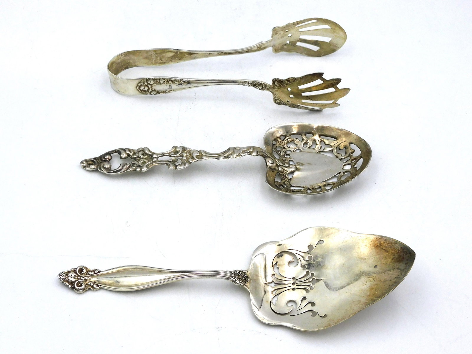 (3) Sterling Silver Serving Pieces: 19th/ 20th century. To include: A) 8" long spoon marked sterling. Shows light surface scratches. Consistent with age and use. B) 8 7/8" long server marked sterling. Shows some surface scratches. C) Pa
