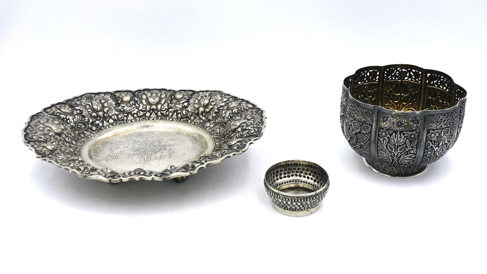 (3) Asian Export Silver Items: 19th/20th century. To include: A) Repousse footed bowl with floral motifs and reticulated top. Probably Indian. Possibly a gourd form. Tested sterling silver. No hallmarks. 4" high x 5 1/4" diameter. 