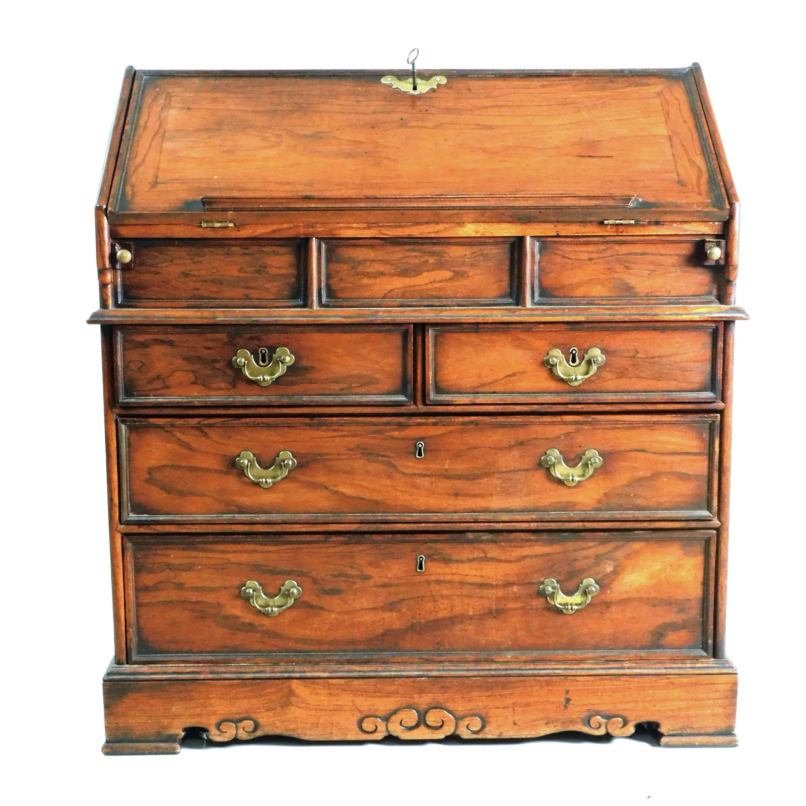 China Trade Slant lid Desk: 18th/19th century. Padouk wood. Slant lid, step fitted interior with six drawers and one door. Slide opens to recessed compartment. The case has two small drawers over two large graduated drawers. Sup