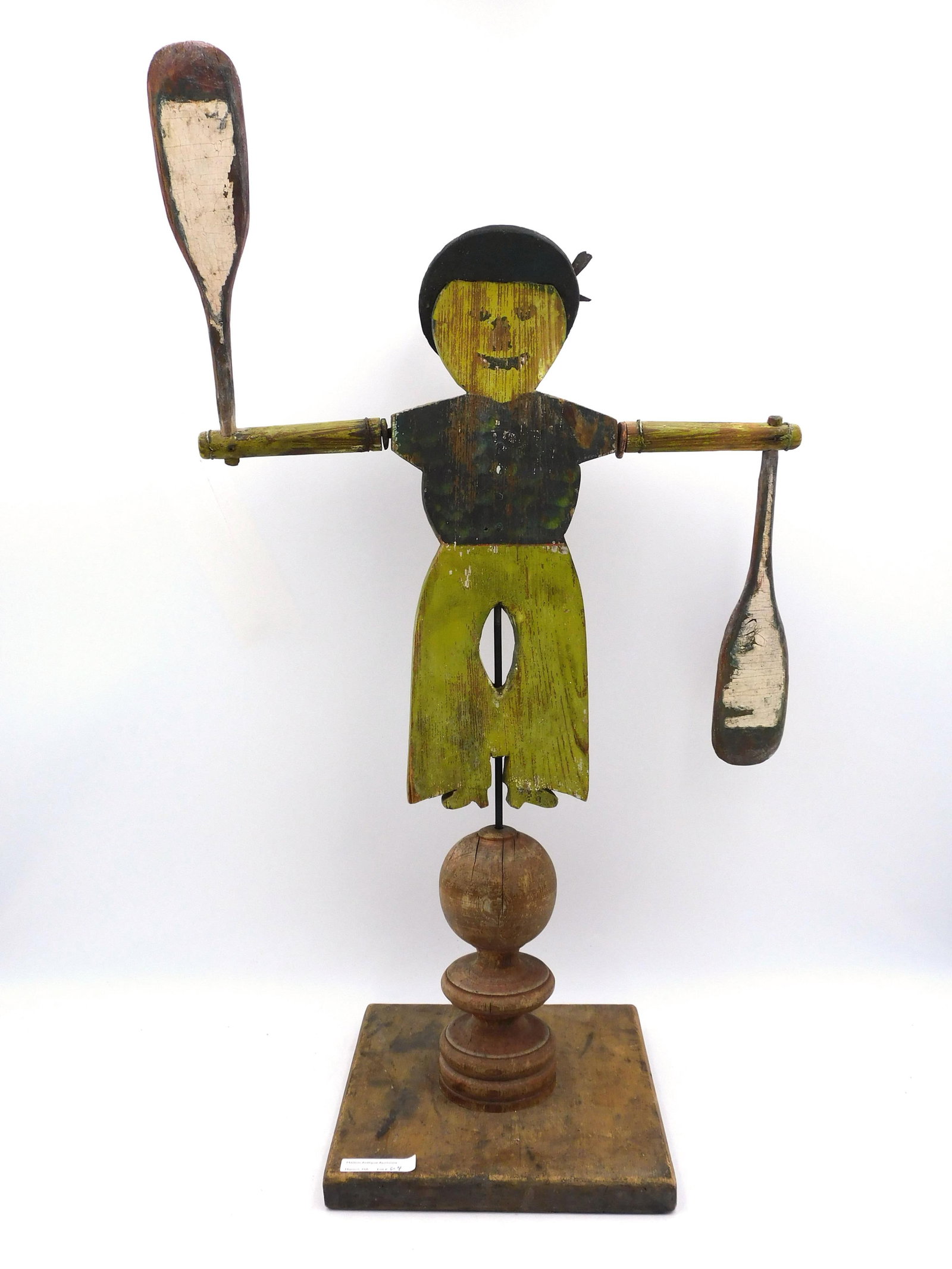 Sailor Whirligig: 19th century. Depicting Jack Tar with revolving arms and paddles. Mounted on a 19th century wooden stand. 26" high x 15" wide with 9" x 8" base. Good condition with worn paint, possibly original.