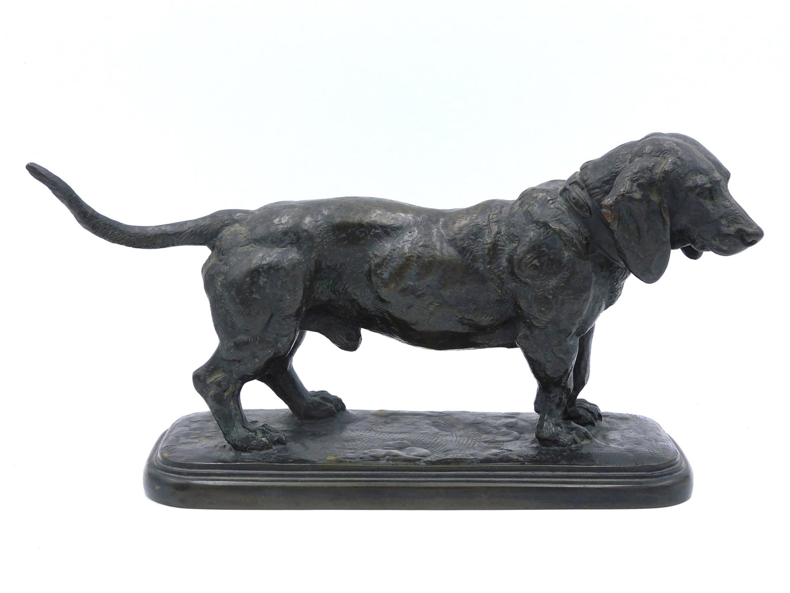 After Antoine-Louis Barye, Bronze Sculpture: (French, 1796-1875). Sculpture of a Basset Hound. Signed on the back of base. Stands atop a stepped base. 6 1/2" high x 12" long x 4" wide. Good condition.