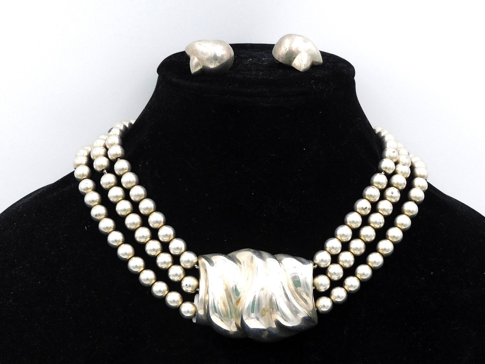 Patricia Von Musulin Necklace and Earrings: Heavy Sterling Silver. Necklace is beaded, multi-strand Torsade. 16" long. Earrings are clip-on. Approx. 1" long. Overall good condition. 5.2 ozt. Shipping Restriction: Please note this lot must be pa