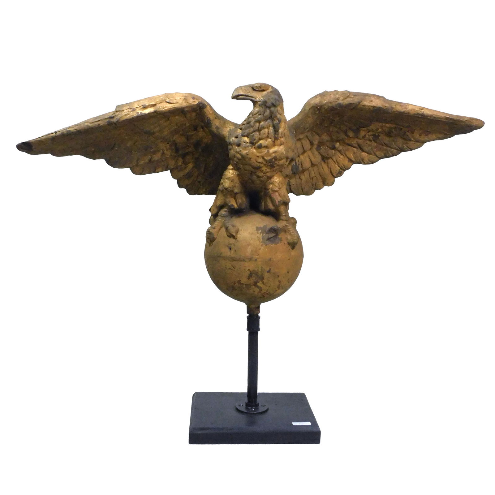 Gilded Copper Eagle: 19th century. American. Possibly from a ship's pilot house or an architectural element on a building. Has a wonderful old patinaed surface. Unusually large. Eagle is perched on a large gilded ball and