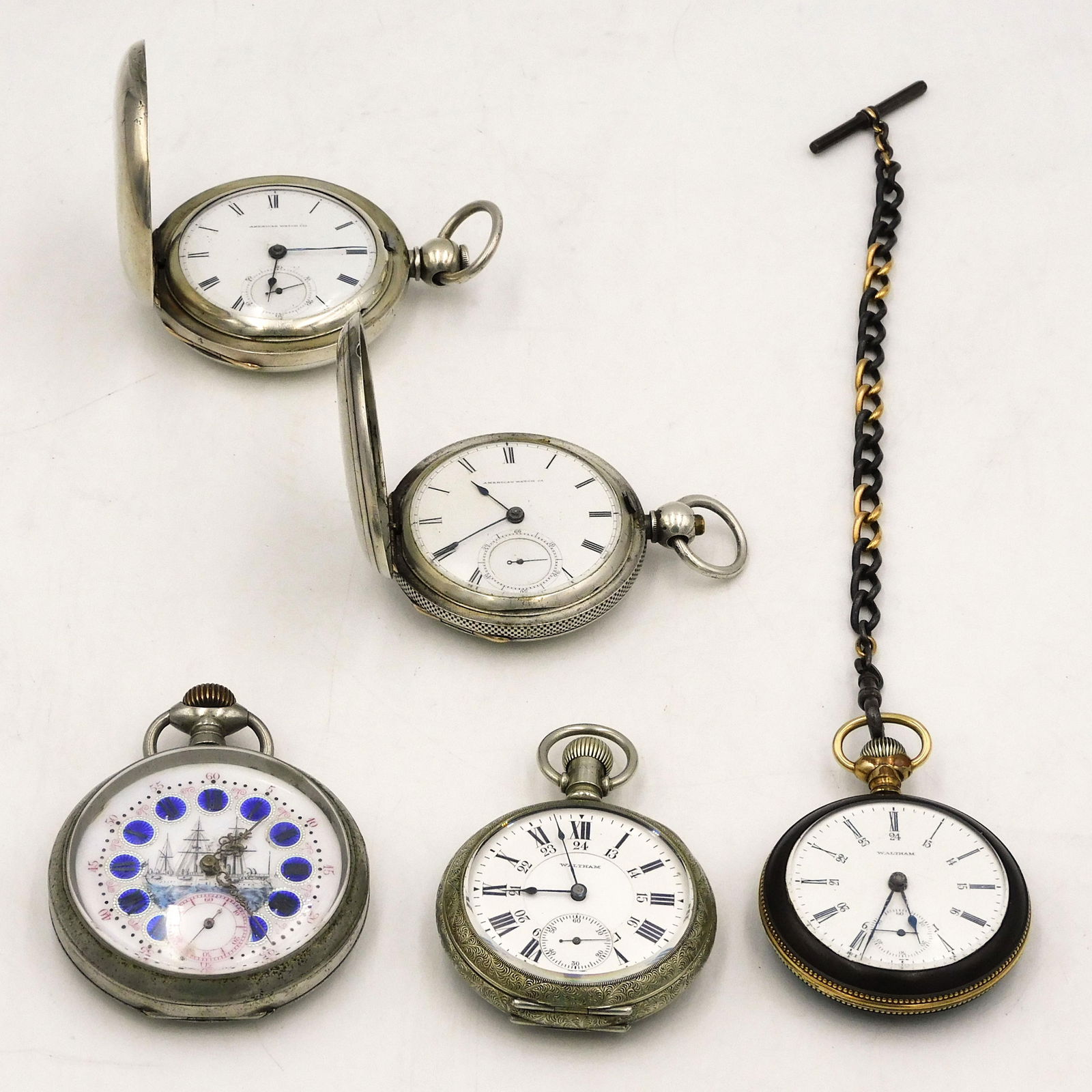 (5) Quality Pocket Watches: To include: A) Nickel silver, enameled dial with ship. Lever set. 2 1/2" diameter. B) Waltham 17-jeweled Canadian Pacific Railway. Black finish case with engraved gold inlaid locomotive. Matching fob.