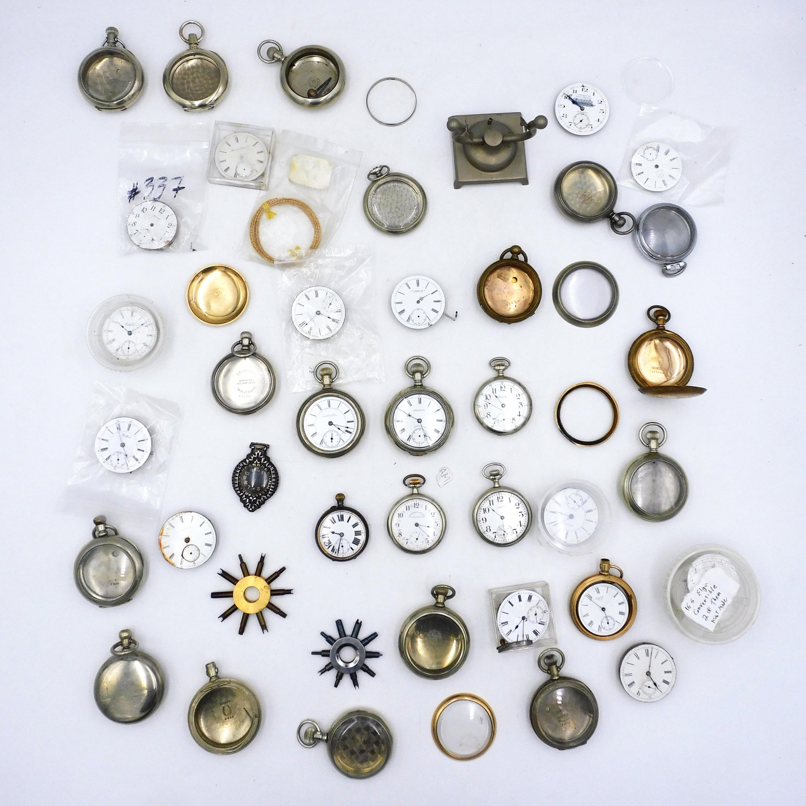 Pocket Watches and Parts: To include: (7) watches with nickel cases, along with parts to include cases, movements, tools, etc. Not guaranteed to work. Provenance: From the estate of Alan Gaines of A & A Gaines Antiques, Newpor