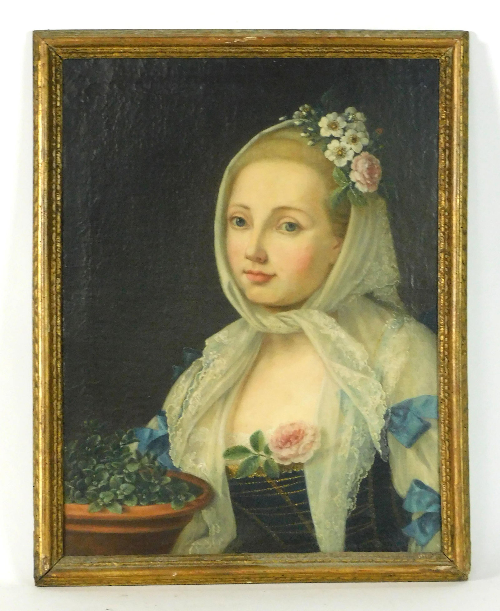 Portrait of a Young Woman with Lace Bonnet: Early 19th century. Unsigned. Sight size: 21.5" high x 16 1/4" wide. In a period carved and gilded frame measuring 24" high x 19" wide. Shows some inpainting to the face and chest. Frame shows minor l