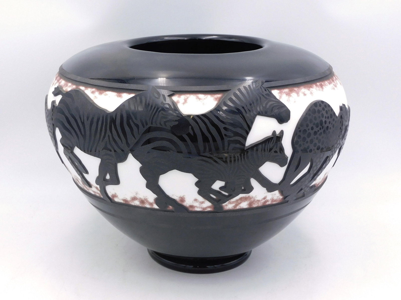Valerie Surjan, Zebra Bowl: (American, b. 1946-). Dated 2001. Cameo glass style bowl signed and dated. Nourot Glass Studio 3604. Numbered 34 / 50. 9" high x 14" diameter. Good overall condition.