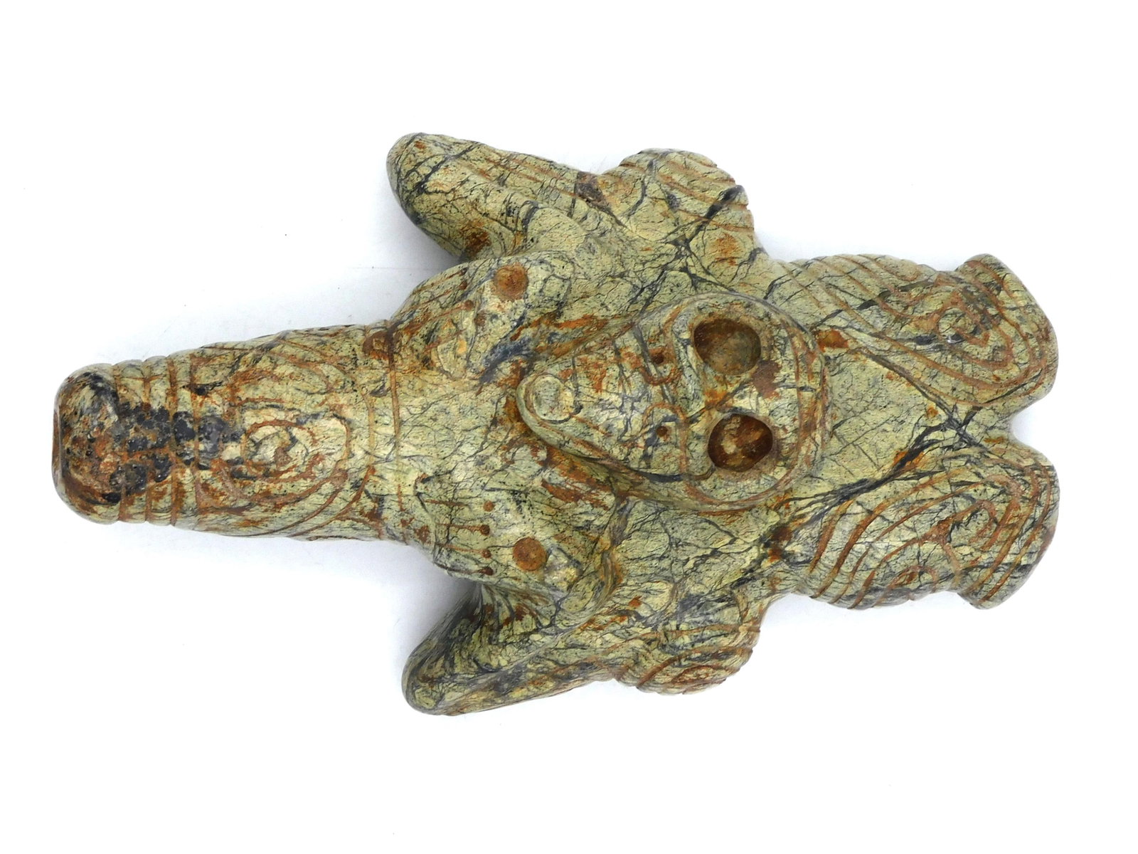 Taino Cohoba or Yopo Snuffer: Circa 600-1550 AD. Light green serpentine with black linear striations. An exceptionally large bird man cohoba snuffer. Well carved bird head graces the center of the inhaler. Anthropic arms define th