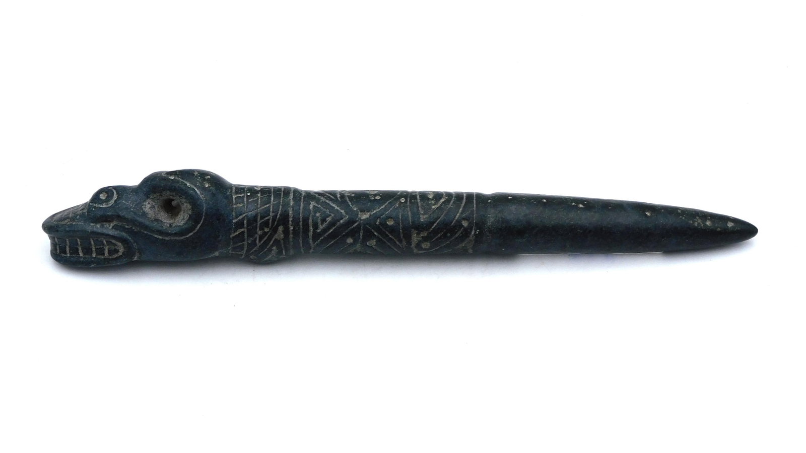 Taino Fertility Fid: Circa 600-1550 AD. Basalt. Zoomorphic fertility fid used to open young maidens during first menstrual period. The animal appears to be a rhinoceros iguana that have a pronounced nob at the central par