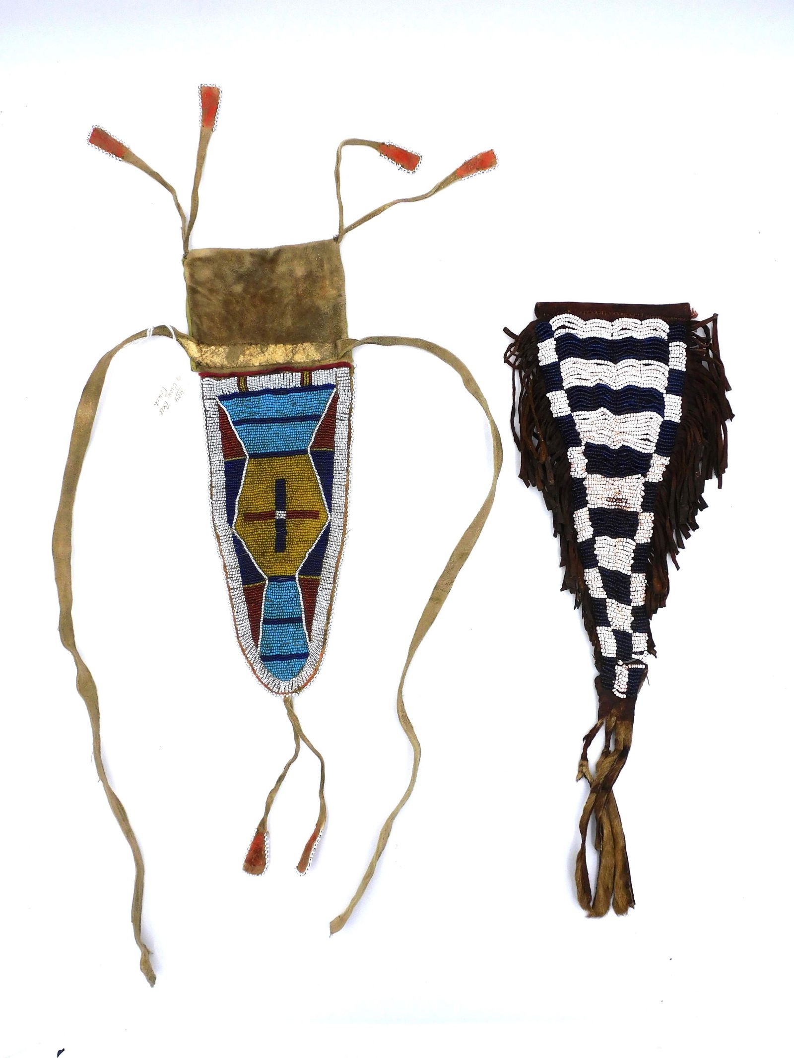 (2) Beaded Belt Pouches: 20th century. Crow multi-colored beaded leather pouch measuring 14" long x 4 1/2" wide. Good condition. Together with black-and-white beaded pouch with fringe measuring 18" long x 5 1/2" wide. Shows w