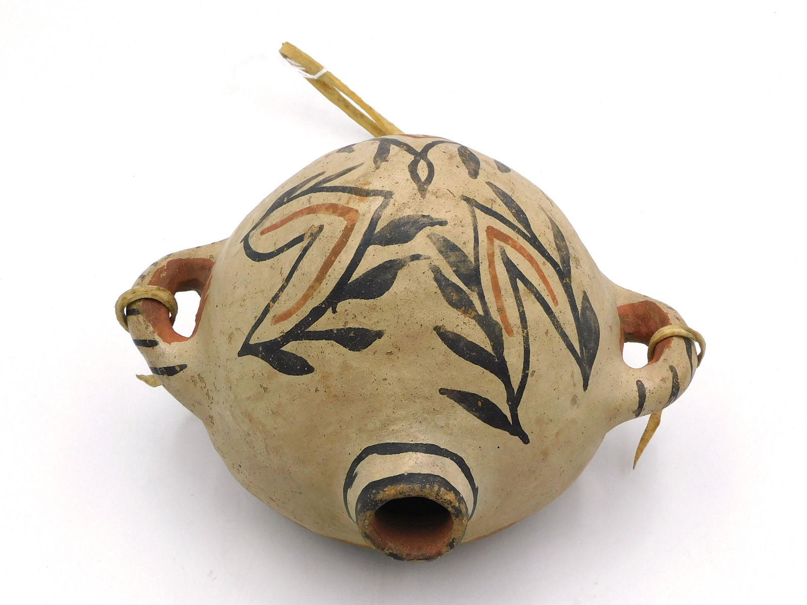 Cochti Pueblo Pottery Canteen: Early 20th century. Double handled, polychrome geometric design. 7" high x approx. 8 1/2" wide x 6 1/2" diameter. Good overall condition.