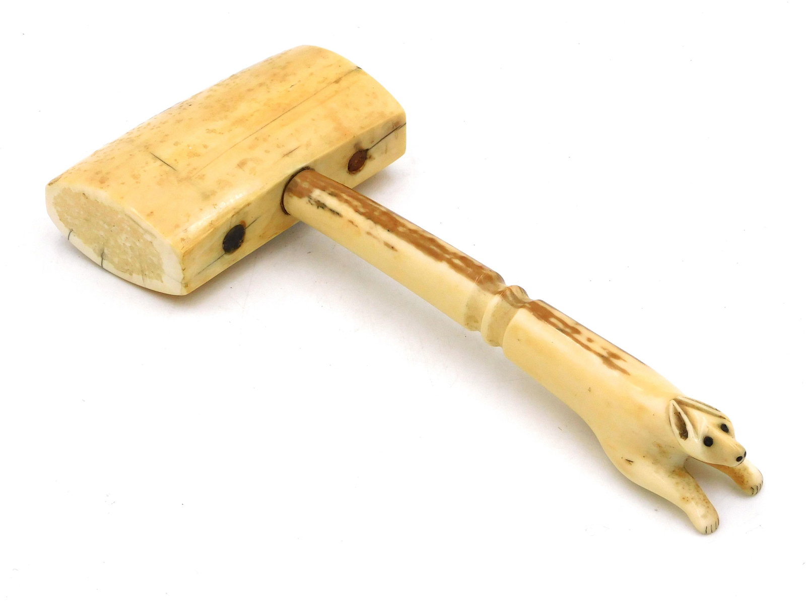 Inuit Effigy Mallet: 19th-20th century. With running carved figure, possibly running fox. 4" wide x 8 3/4" long. Shows several age cracks on mallet sides. Provenance: From the estate of Alan Gaines of A & A Gaines Antique