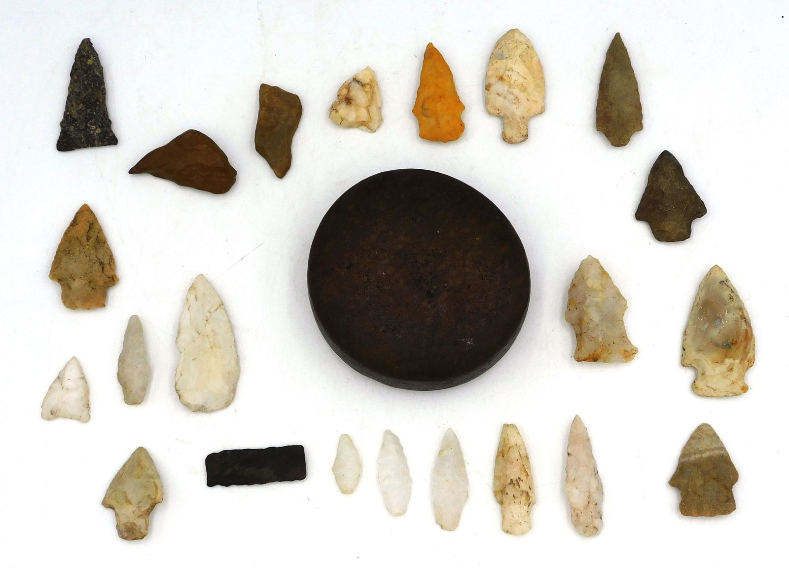 (23) Piece Native American Lot: To include: A) a discoidal 4" diameter x 1 1/3" high. B) (22) miscellaneous antique arrowheads ranging in size from 1" to 2 1/2" long.