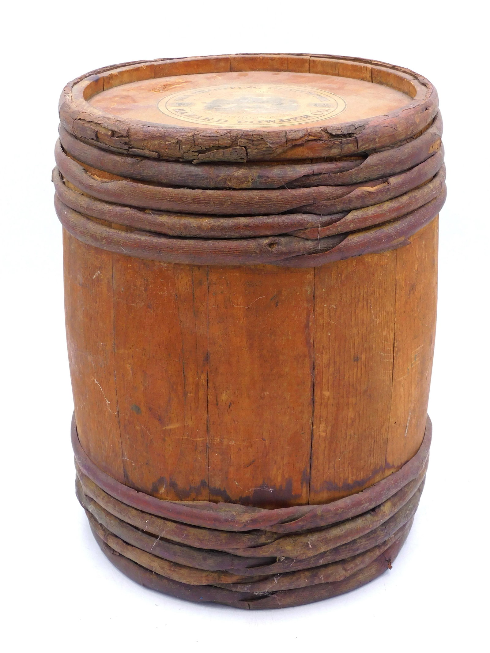 Hazard Wooden Gun Powder Keg: 19th century. The keg has wood wrapped stave construction with original paper label. Sea shooting gunpowder, manufactured in Hazardville, Connecticut. 13 1/4" high x 10 1/2" diameter. Age appropriate 