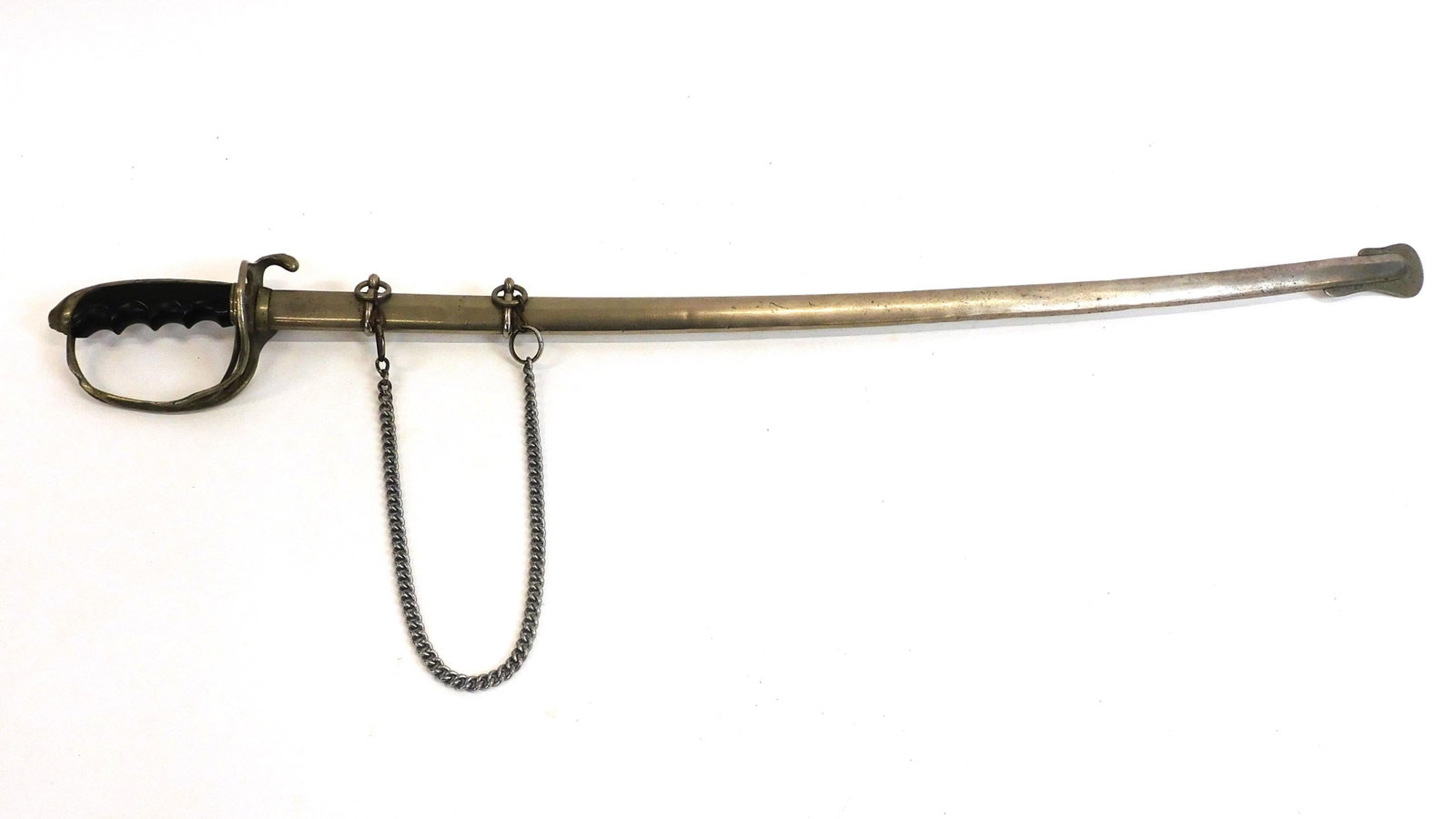 Cavalry Sword: Late 19th century. Carved wooden handle, metal hilt. Metal scabbard. 37" long. Blade shows some corrosion.