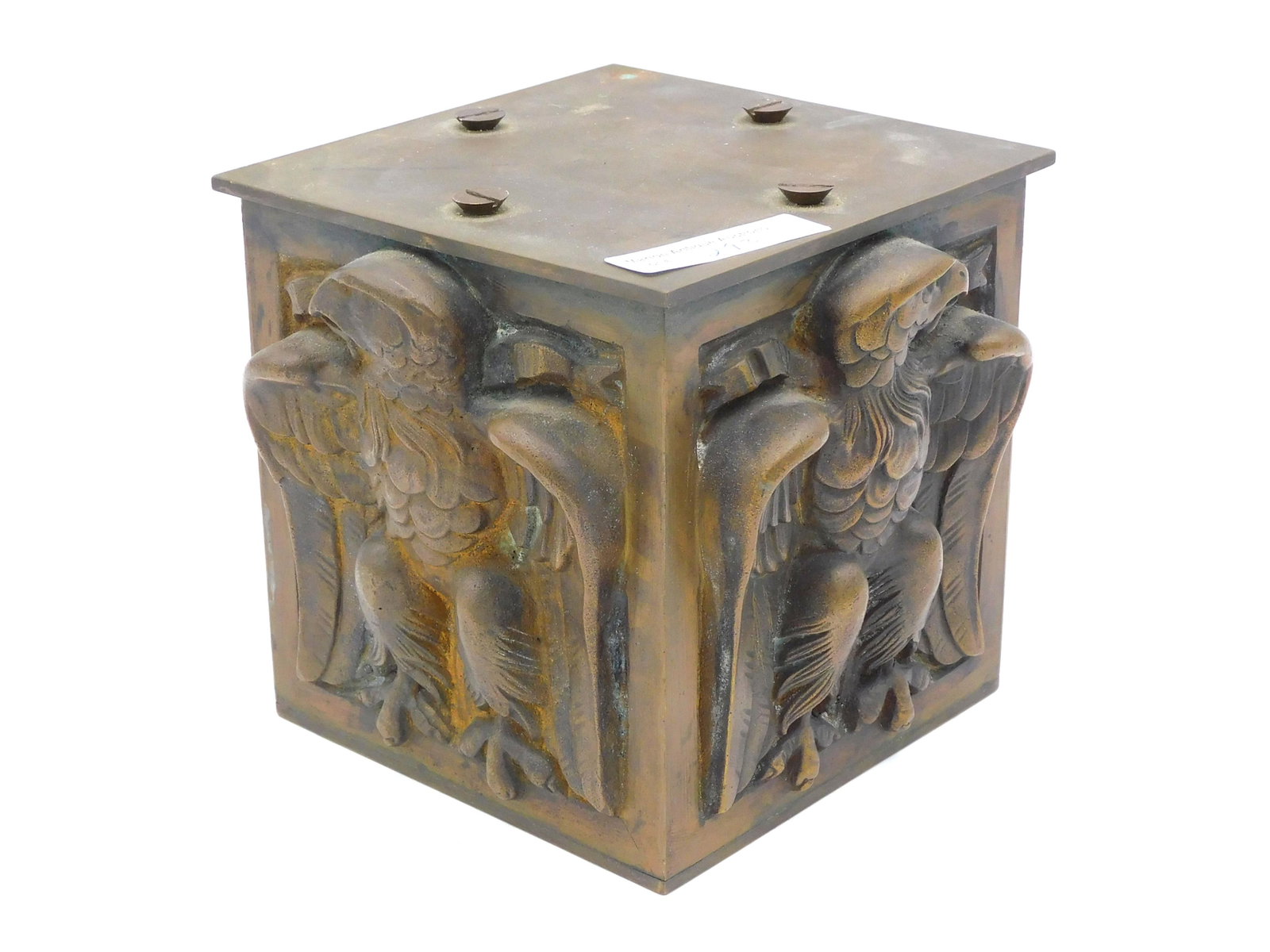 Eagle Motif Brass Pedestal: 19th century. Raised eagle design on four sides. 5" square. Good condition. Provenance: From the estate of Alan Gaines of A & A Gaines Antiques, Newport, Rhode Island.