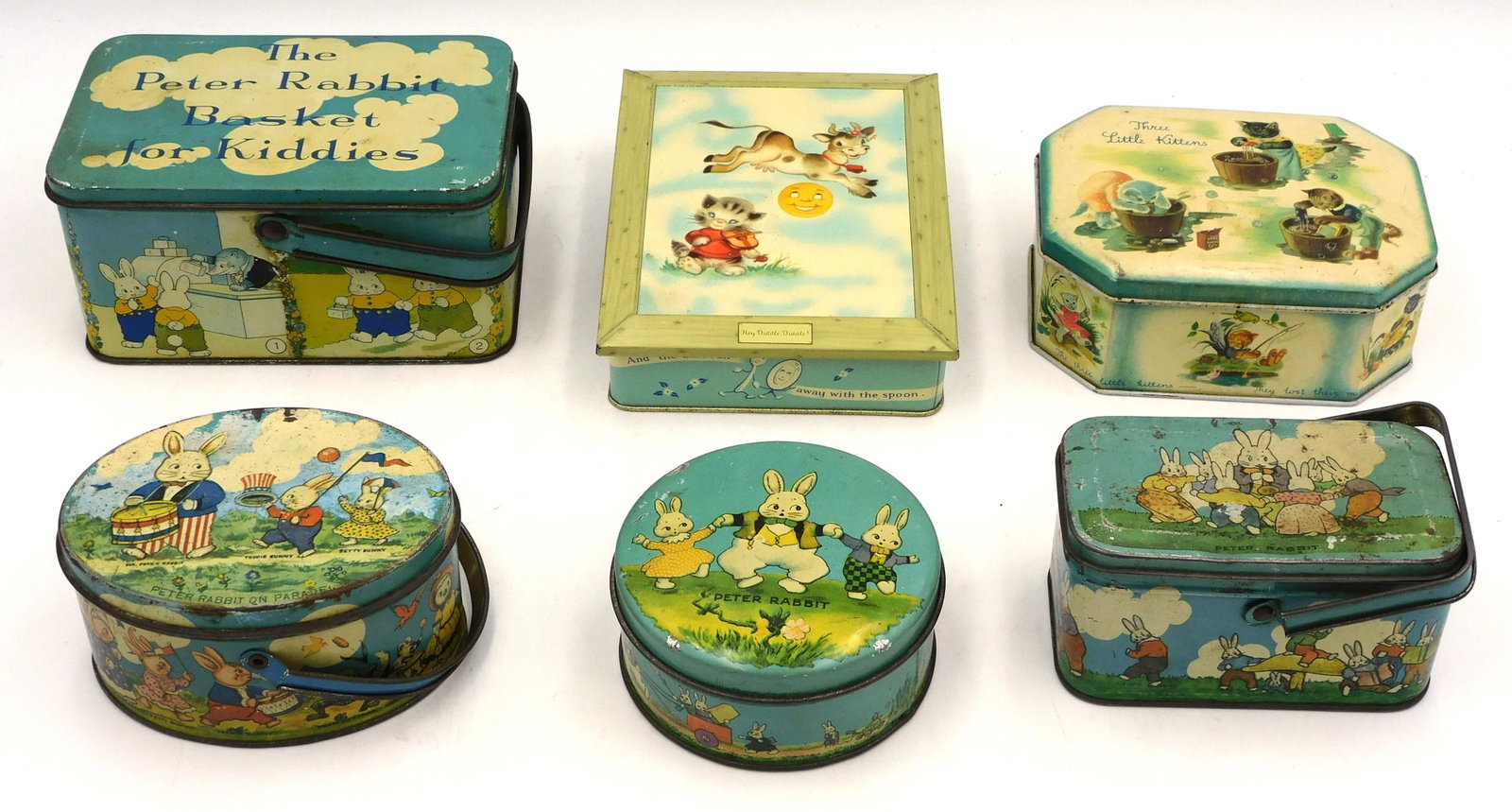 (6) Vintage Tin Easter Boxes: To include: A) "Peter Rabbit Basket for Kiddies" swing handle box. 3" high x 6" wide x 4" deep. Shows moderate wear to paint. B) Peter Rabbit and Friends swing handle box. 2 1/2" high x 4 1/2" wide x 