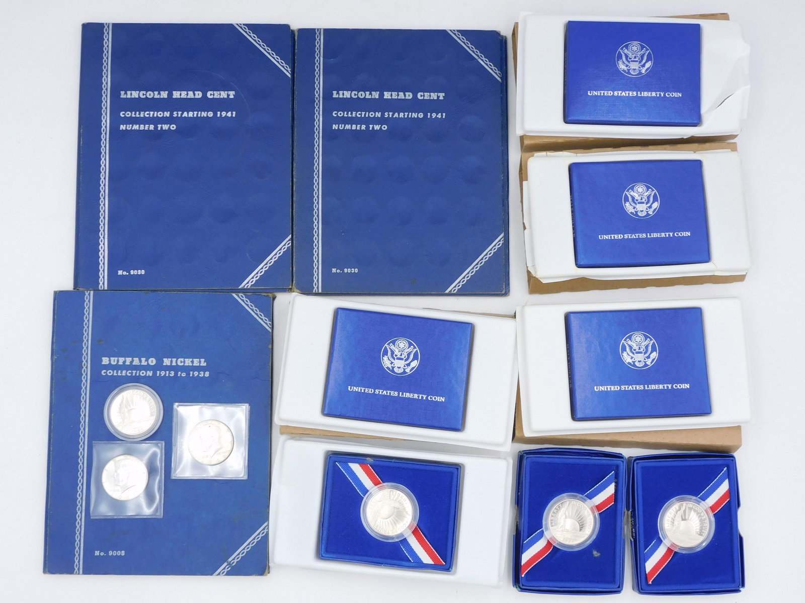 Coin Collection Lot: To include: (8) 1986 Liberty Island proof coins. 1966, 1967 Kennedy halves, 1941 full and partial Lincoln Head cents, (4) Buffalo Nickels in book. Shipping Restriction: Please note this lot must be pa