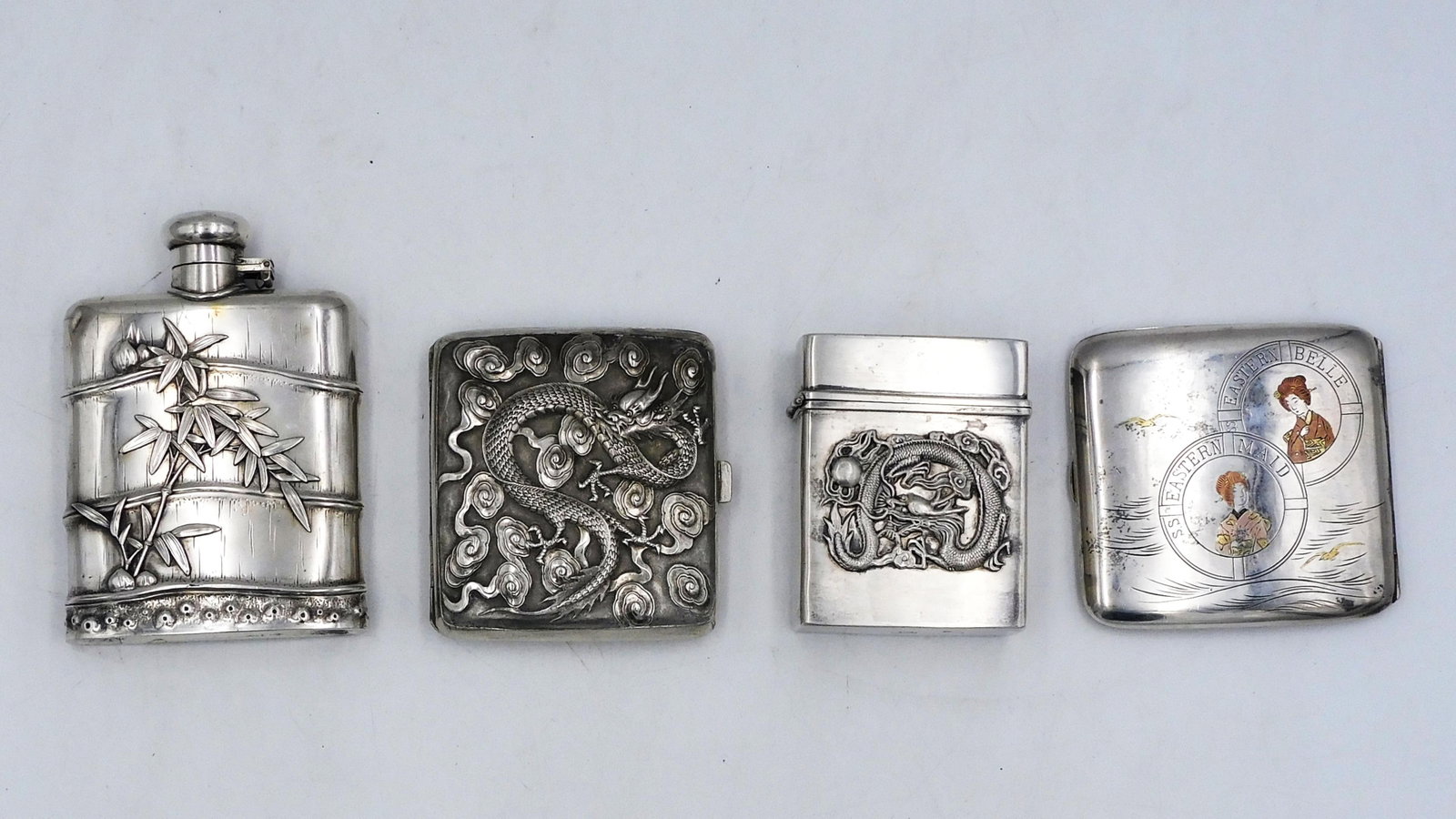 (4) Asian Silver Objects: To include: A) Japanese silver cigarette case. From the S.S. Eastern Belle and S.S. Eastern Maid, Japanese passenger ships. Engraved on interior: "In remembrance of the construction of the Eastern Bel