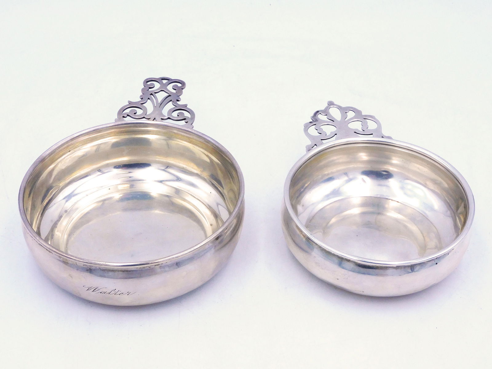(2) Sterling Silver Porringers: To include: A) Gorham. Inscribed "Walter" on side. 2" high x 7 1/2" x 5". B) Whiting. 6" x 4 1/4". Multiple dents in silver. Overall weight: 8.90 ozt. Shipping Restriction: Please note this lot must b