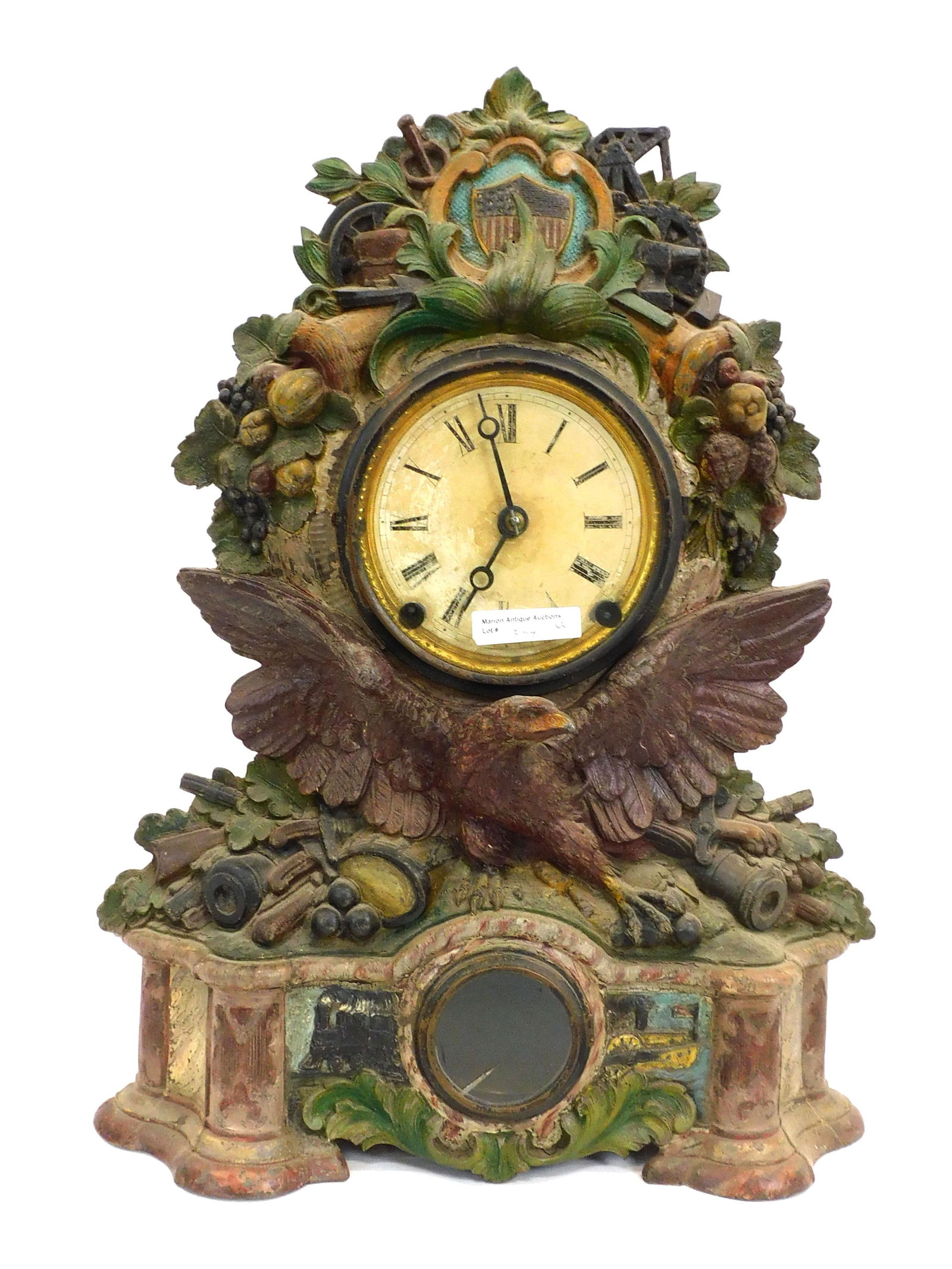 American War Themed Clock Plus Additional Clock: 19th century. Possibly Civil War. Cast iron. Top crest has an America flag shield surrounded by cornucopia with fruit, painted metal dial, supported by a winged eagle, flanked by canon, drums and musk