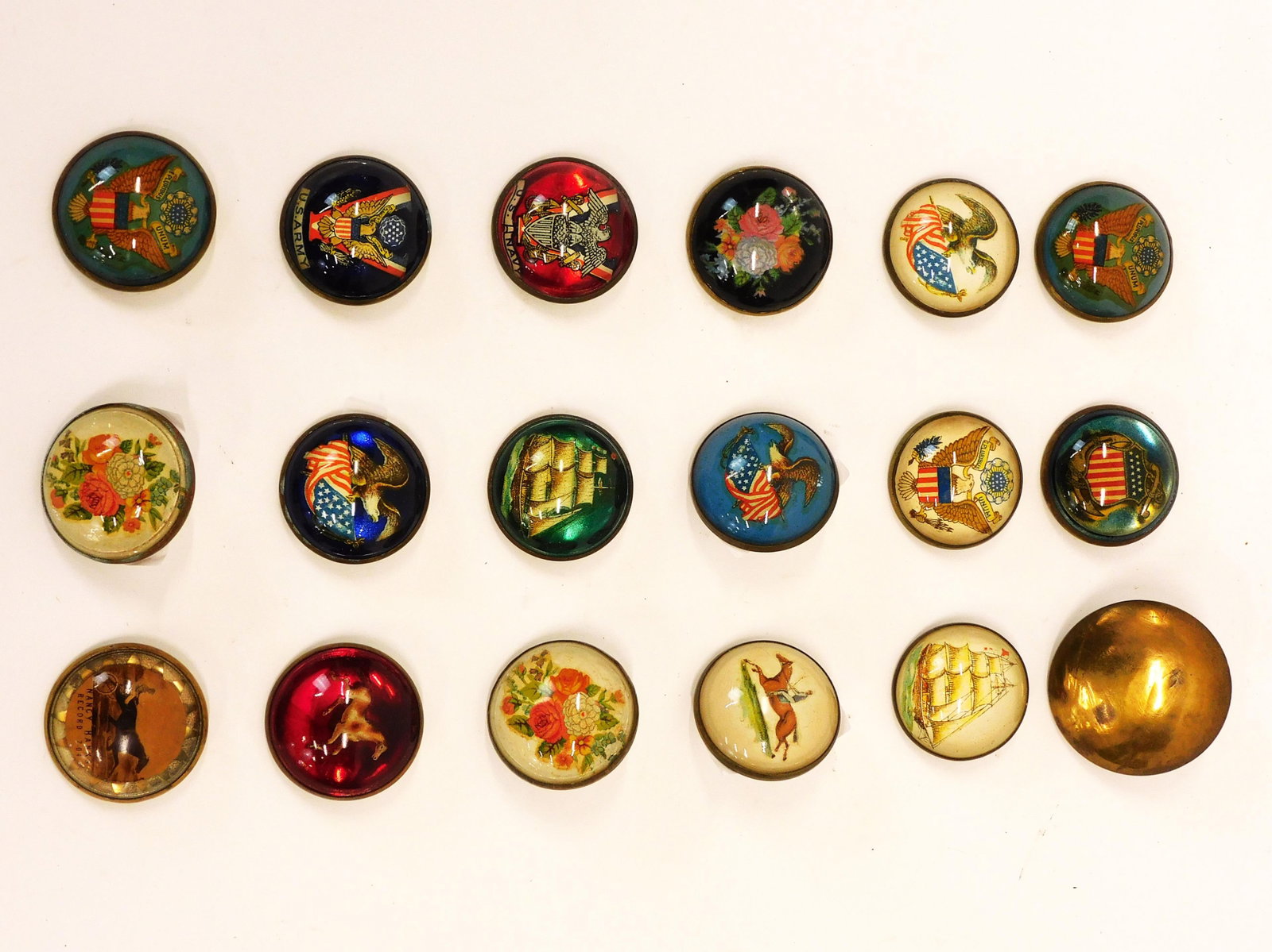 (18) Pins and Buckles: Late 19th century. To include: A) Plain brass buckle. 2 1/4" diameter. B) (17) paperweight design: (2) clipper ship pins; (3) equestrian pins; (2) buckles with floral design; (1) pin with floral desig