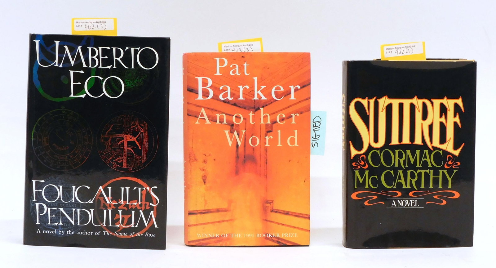 (3) Books by Cormac McCarthy Pat Barker Umberto Eco: To include: A) "Suttree". Cormac McCarthy. Random House 1979. First Edition. Unclipped dustjacket in good condition with Doubleday sticker on back. 8 1/2" high x 5 3/4" wide. B) "Another World". Pat B