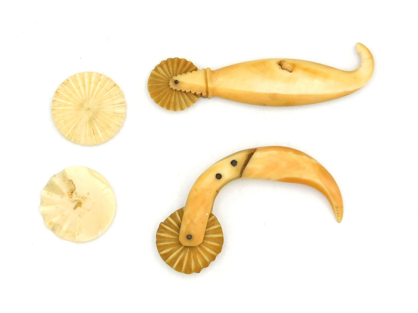(2) Scrimshaw Jagging Wheels: 19th C. Together with two spare wheels, one incomplete. 4 1/4" long and 5 1/8" long. Wheels are 1 5/8" diameter. Shipping restriction: Please note this lot is not available to be sold or shipped inter