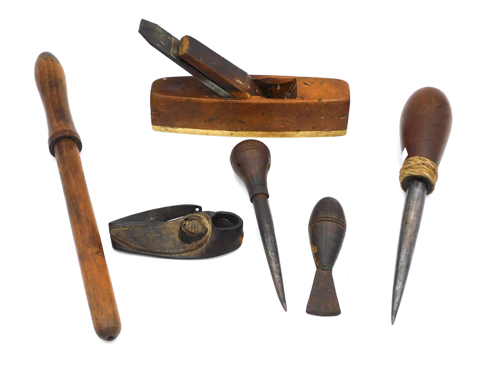 (6) Sailor's Tools: 19th C. To include: (A) Block plane with whalebone base. Buck Bros. blade. 5" high x 6" long. (B) Large wood handled awl with ropework trim. 11 1/2" long. (C) Wood handled awl. 7 3/4" long. (D) Turned