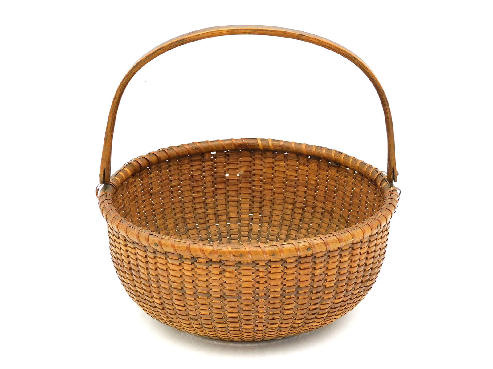 Nantucket Swing-Handle Basket: Early 20th C. Made by Ferdinand Sylvaro, Nantucket. 9 1/4" overall x 8 3/4" diameter.