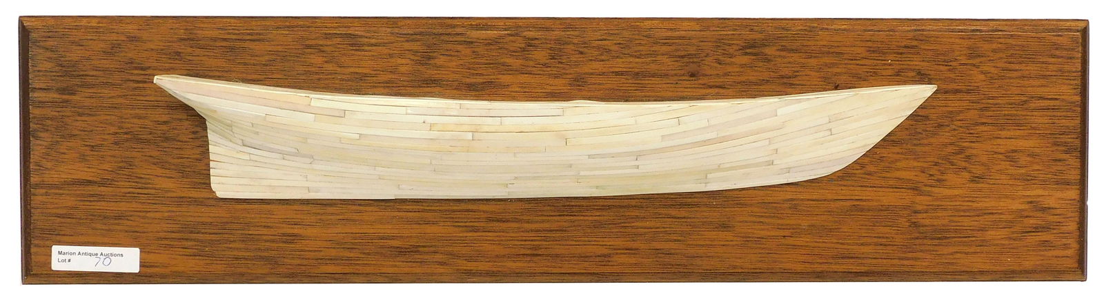 Planked Half-Hull Model: 20th C. Whalebone planks mounted on oak board. 5 1/2" high x 22 1/2". Boat length 15 1/2". Shipping restriction: This lot is not available to be shipped out of Massachusetts. It is the responsibility