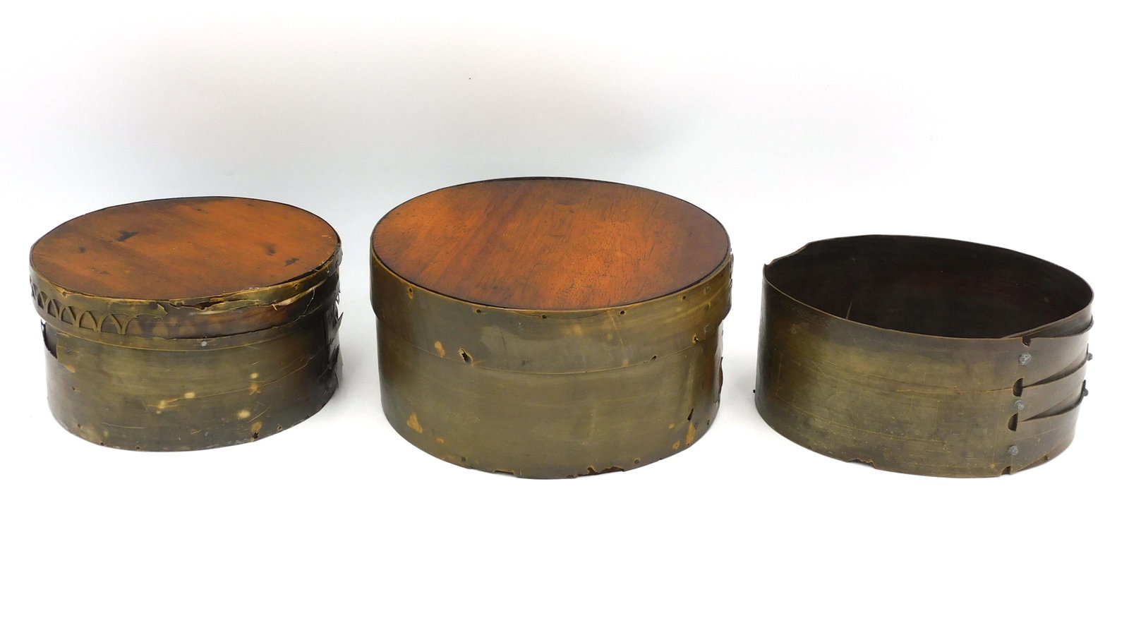(3) Scrimshaw Baleen Ditty Boxes: 19th C. Wrapped construction. To include: (A) Oval ditty box with three fingers. Scrimshawed with miscellaneous buildings, trees. etc. 3" high x 6 1/4" wide x 5" deep. (B) Round box with geometric ope