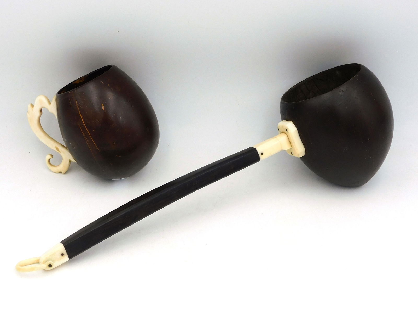 (2) Coconut and Whale Tooth Scrimshaw Dippers: To include: (A) Handled mug style dipper. 4" high x 3 1/2" diameter. (B) Long handled dipper. 4 1/2" high x 14" long.