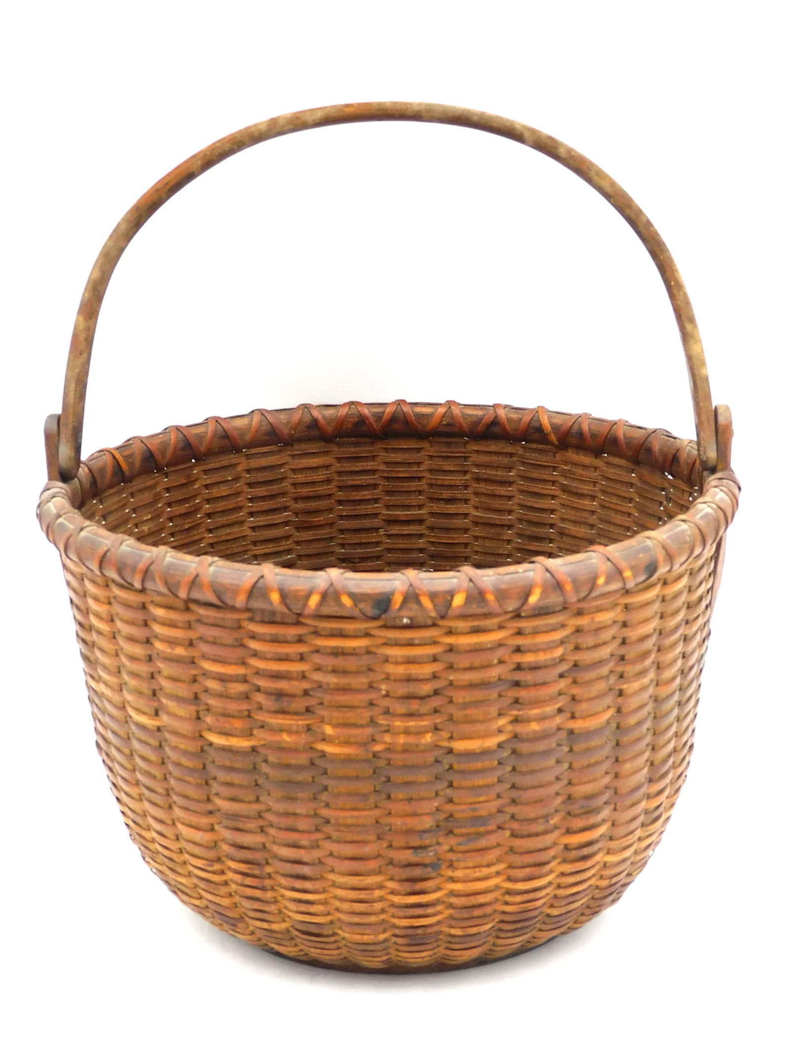 Rowland Folger Nantucket Swing-Handled Basket: (American/Massachusetts, 1803-1883). 19th C. Double wrapped rim, wood stave. Signed, bottom center. Illegible markings on handle. 11" high x 9 1/4" diameter.