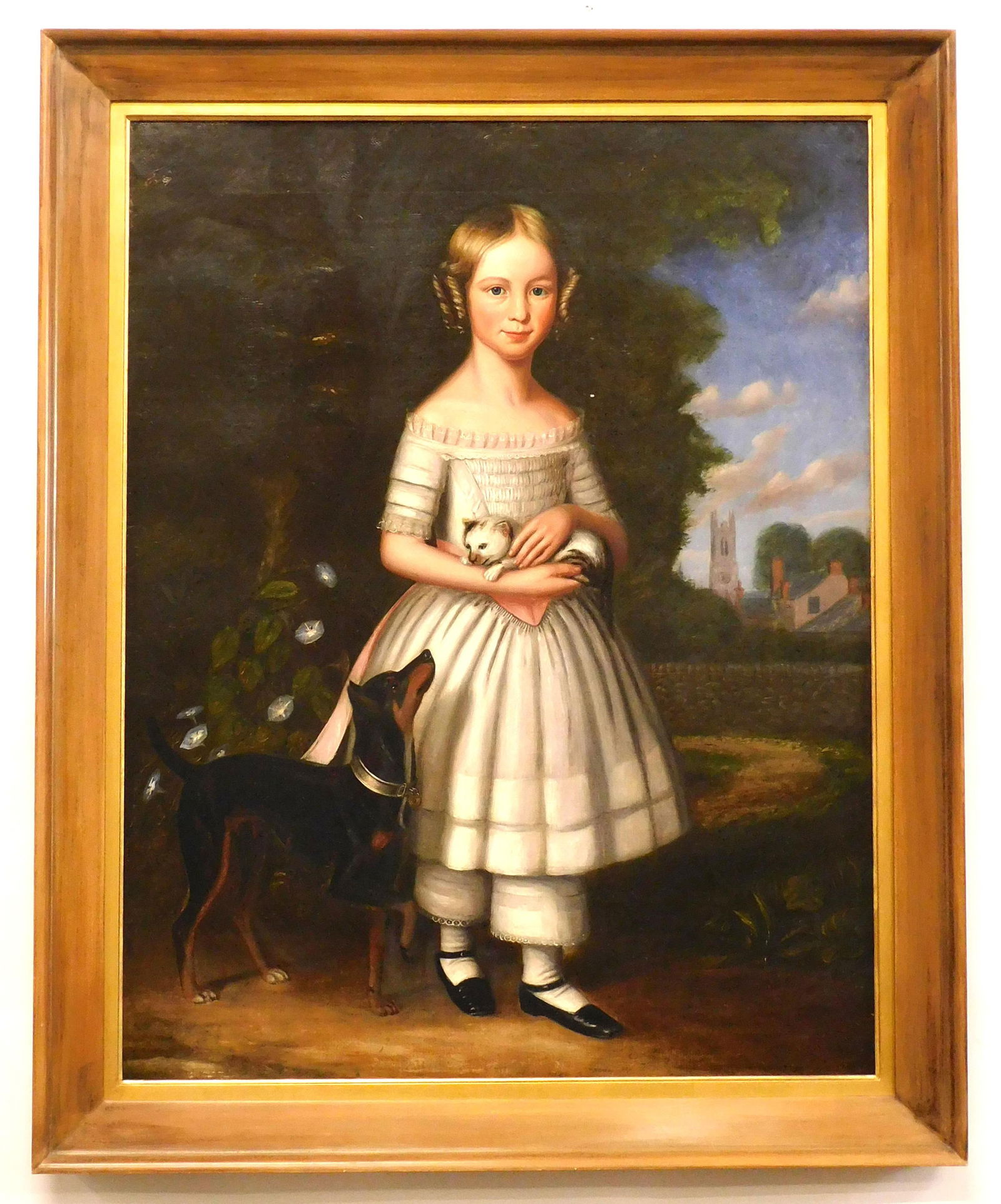 Joseph Goodhue Chandler (Attributed) Painting: (American/Massachusetts/New York, 1813-1884). Ca. 1840-1850. Oil on canvas. Young girl holding kitten with dog looking on. Collar of the dog has the name "Belper" which is a town in England. Church in