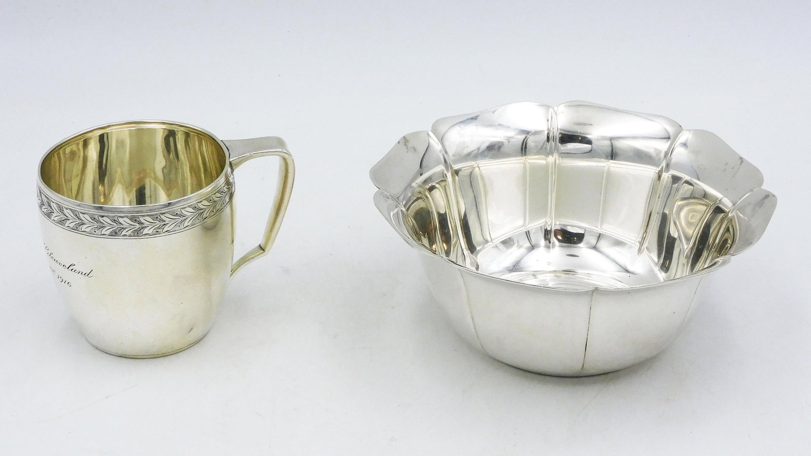 (2) Tiffany Sterling Silver Pieces: To include: (A) Bowl with scalloped border and ribbed sides. 2 3/8" high x 5 3/4" diameter. 6.98 ozt. (B) Tiffany mug. Engraved border and engraved "Albert Sampson Cleveland, November 10, 1916". 2 3/4