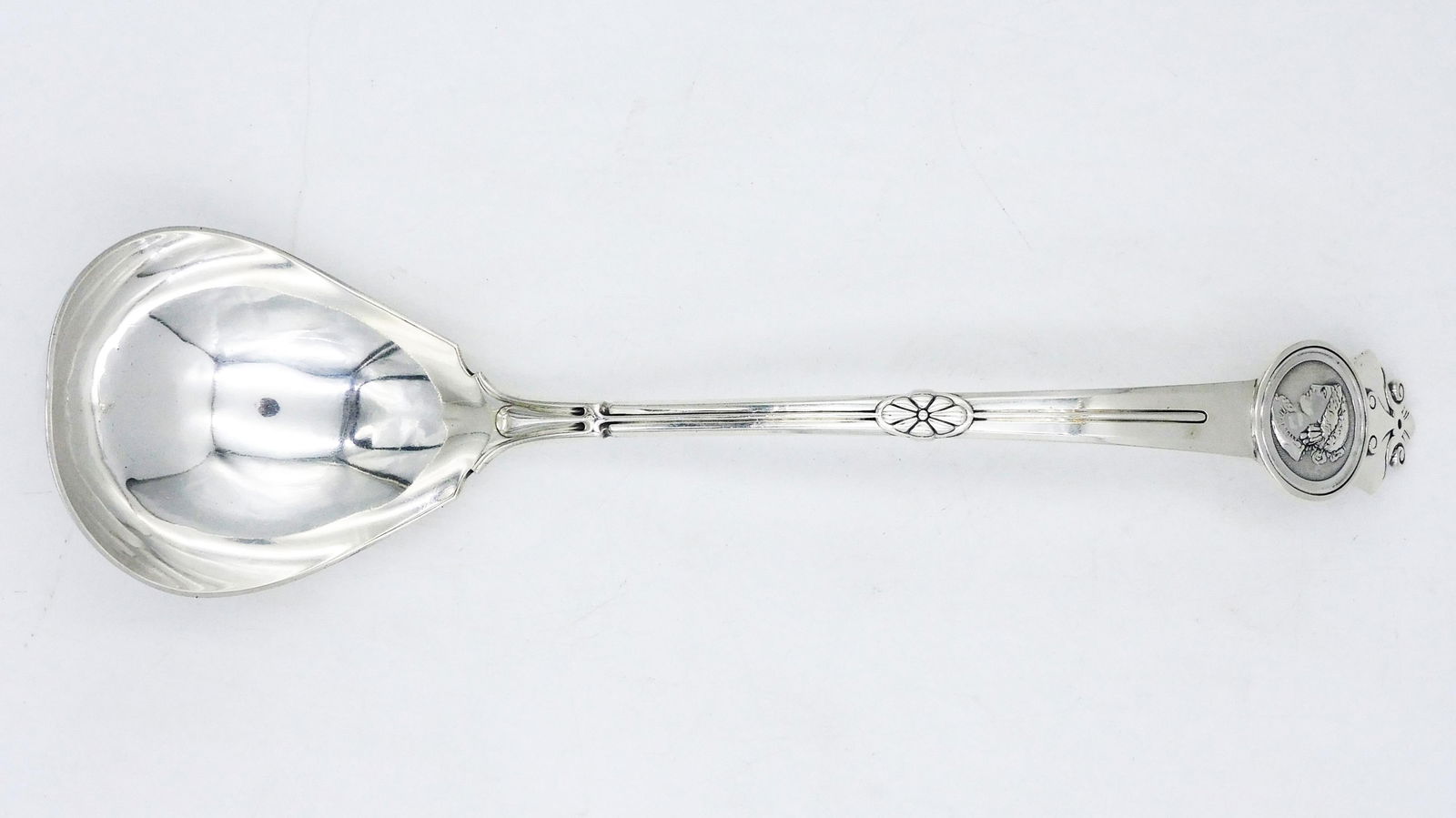 Gorham Sterling Silver Medallion Ladle: 19th C. Neo-classical head. Retailed by George C. Shreve & Company. 13 3/4" long. 7.51 ozt. Provenance: A Newport, Rhode Island collection. Please note this lot must be paid for by cash, wire transfer