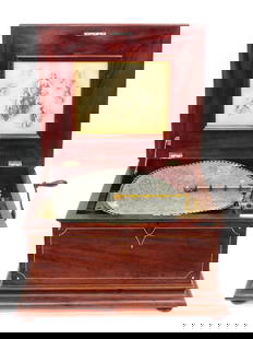 Regina Disk Tabletop Music Box: Late 19th/Early 20th C. Inlaid mahogany case. Casket form. Hinged lid opens to an original lithograph. 13" high x 22" wide x 19 3/4" deep. Comes with a 15 3/4" diameter disk.