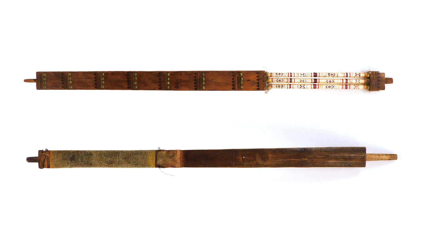 (2) Plains Indian Pipe Stems: Early 19th C. To include: (A) Geometric design quill work. Faded yellow ochre paint. 22 1/2" long x 1 1/4" wide. (B) Geometric design wrapped quill work. Carved geometric designs. Brass tack decoratio