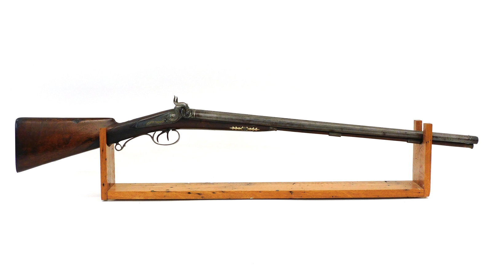 James Purdy Double Barrel Shotgun: 19th C. London. Ornate Damascus barrel. Silver and gold inlay. Inscribed in gold "super fine stub twist". Ornately engraved hammers, plate and trigger guard. Includes secret opening to store extra nip