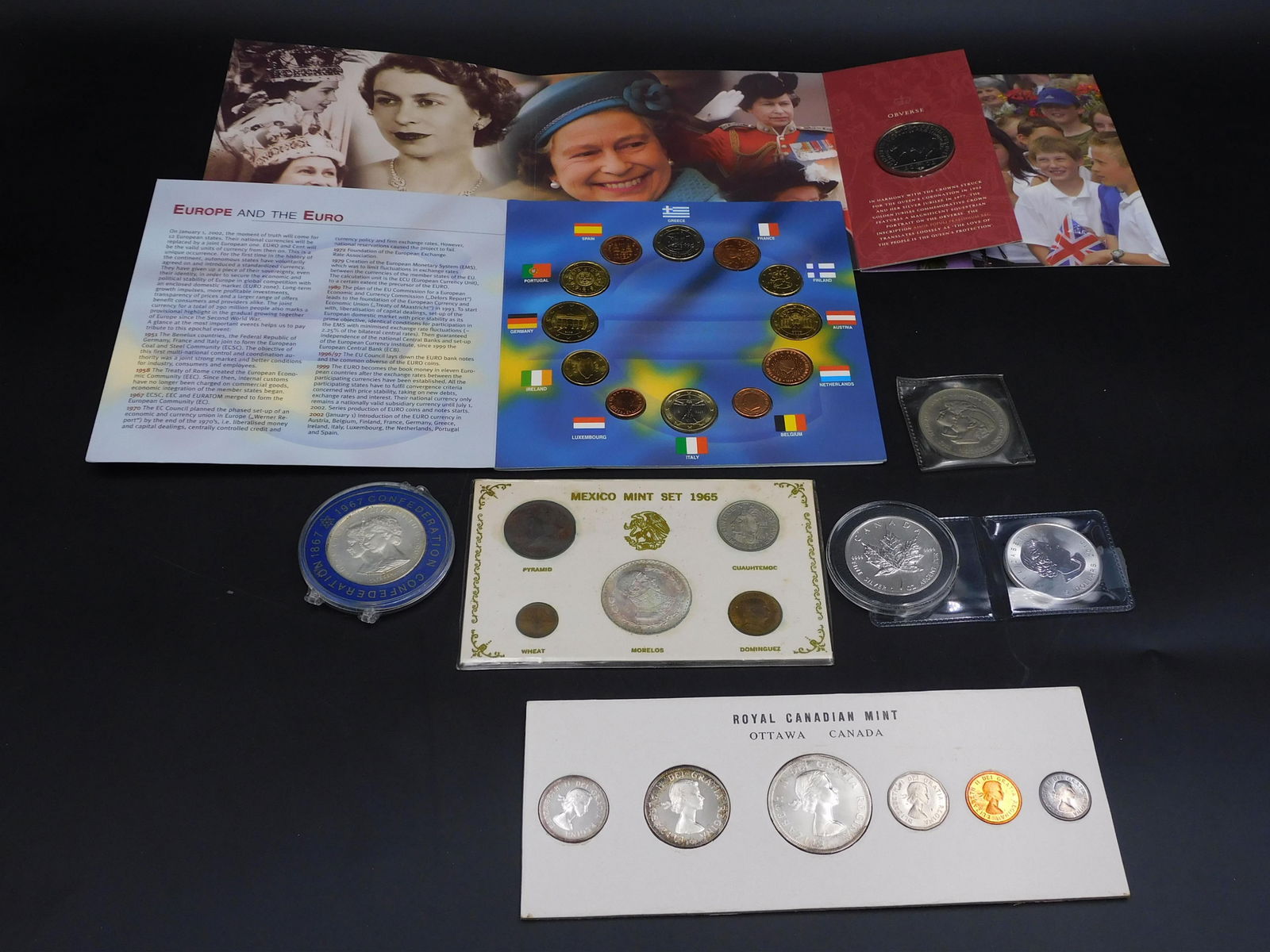Lot of Foreign Coins: To include: (A) (2) Canadian 1 ounce maple leaves. .999 fine. (B) 1981 Charles and Diana commemorative. Silver. (C) 1960 Royal Canadian mint set with silver dollar. (D) 1965 Mexican mint set. (E) 1967